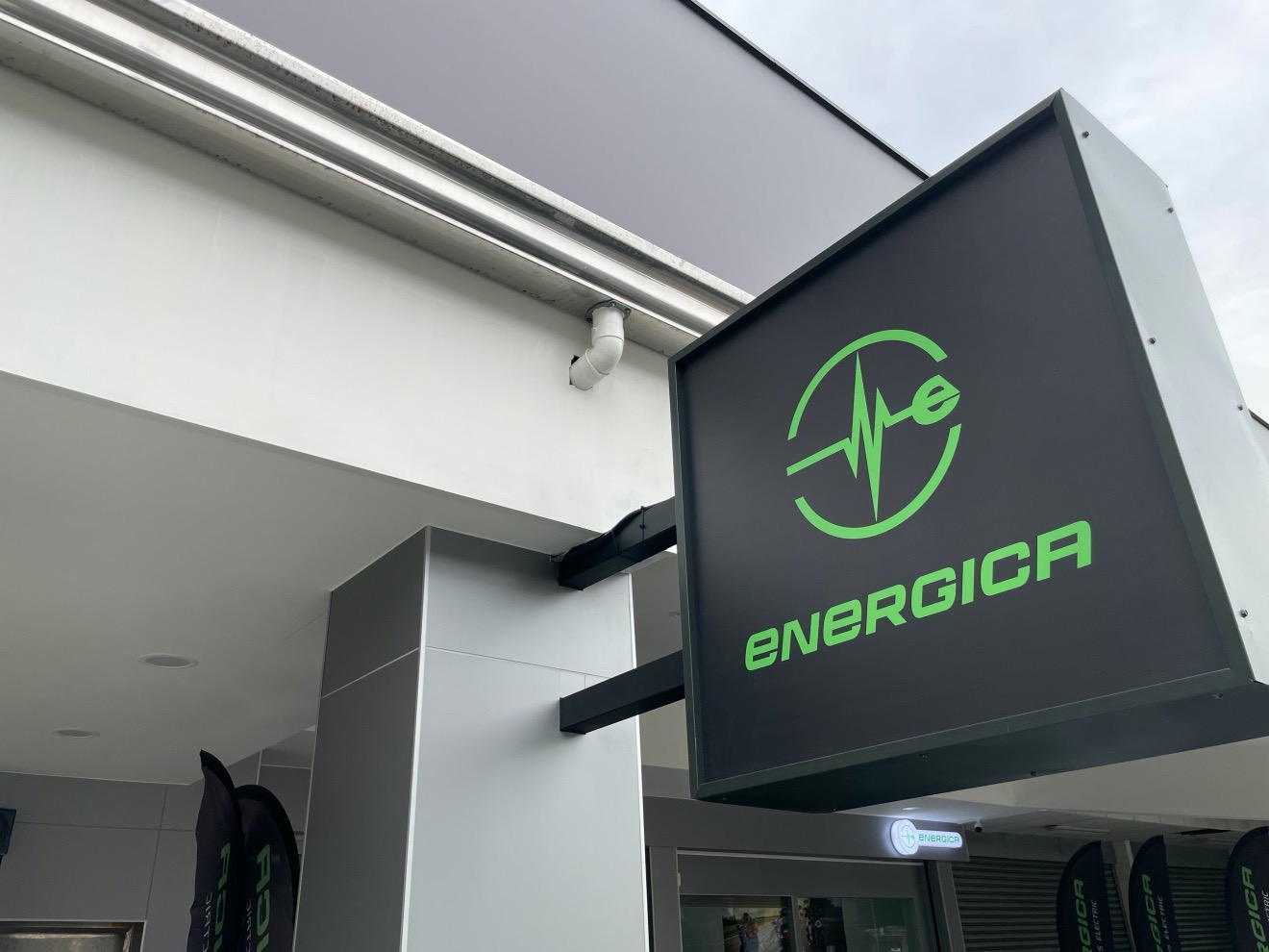 gray sign with green energica logo